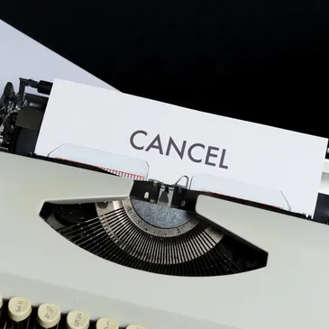 A picture of a typewriter writing a document titled cancel